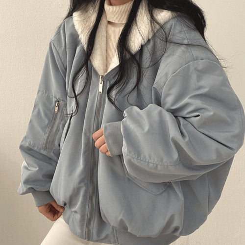 Women's blue oversized fleece-lined zip-up jacket with an arm pocket, casual autumn/winter style.