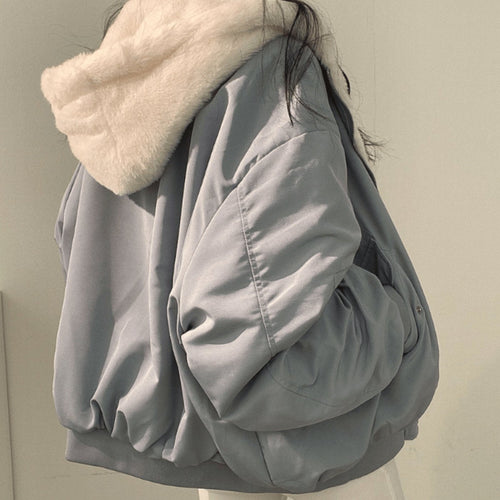 Women's blue oversized fleece-lined zip-up jacket with an arm pocket, casual autumn/winter style.