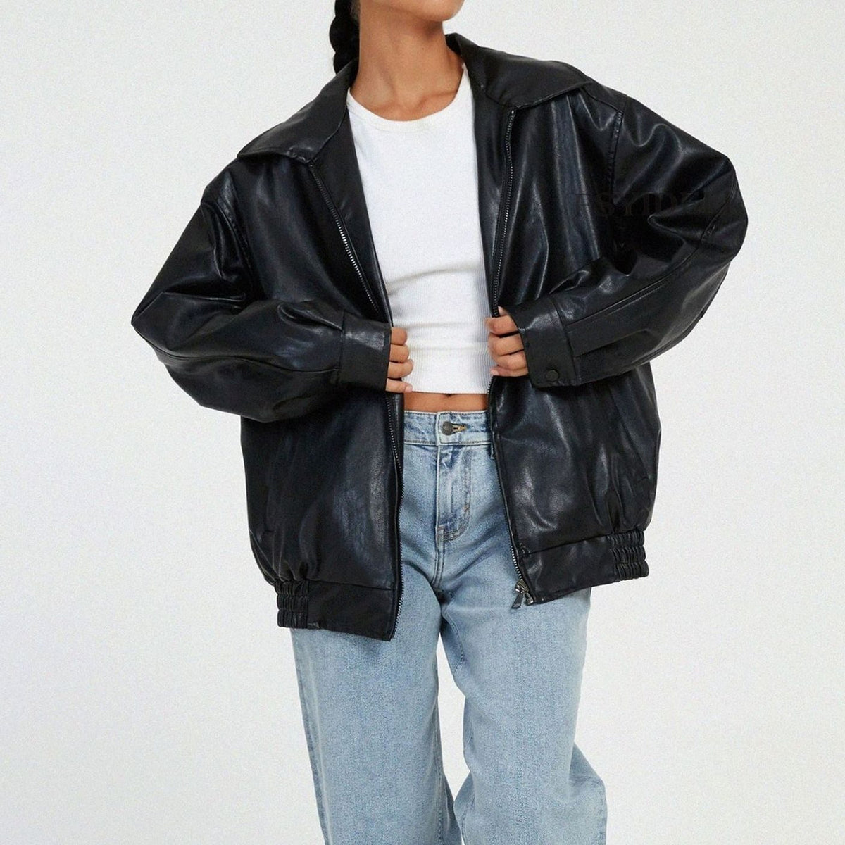 Women's oversized faux leather jacket in brown with a zip-up front and collar
