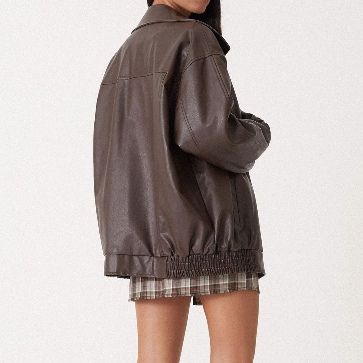 Women's oversized faux leather jacket in brown with a zip-up front and collar