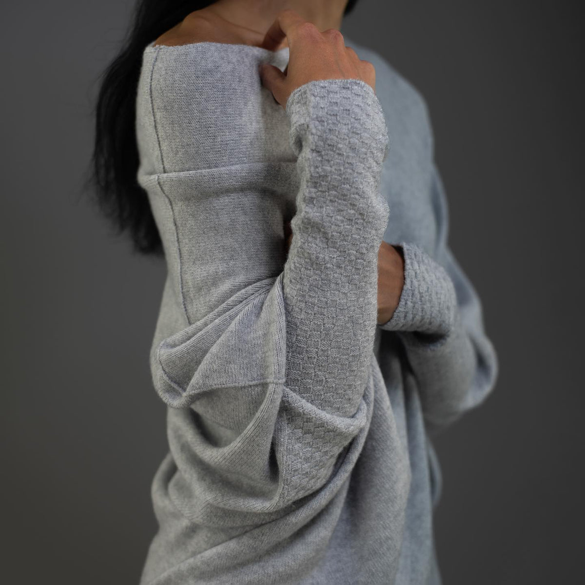Product photo showing the light grey off-shoulder oversized jumper for cosy layering