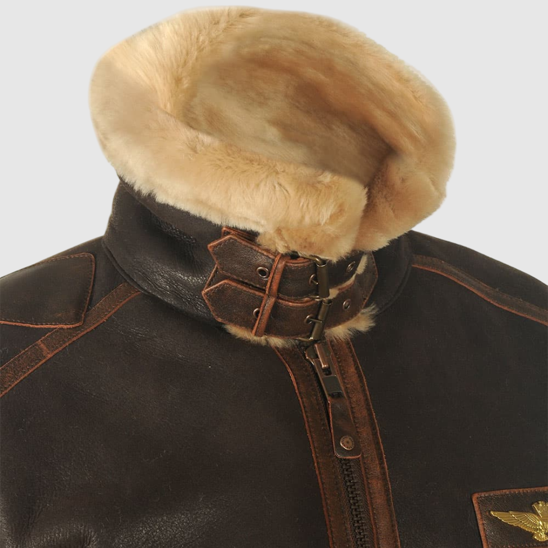 Close-up of the brown leather aviator jacket's shearling collar and buckle strap.