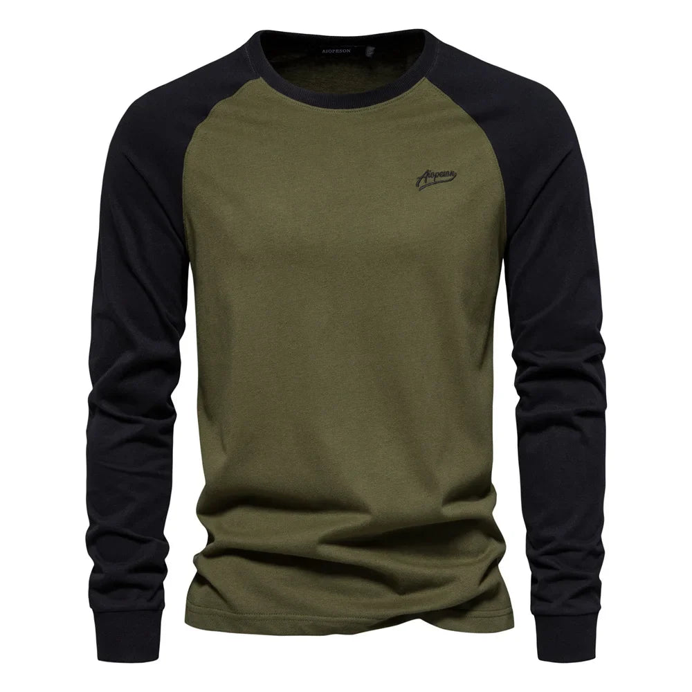 Green raglan long sleeve cotton t-shirt worn with dark trousers