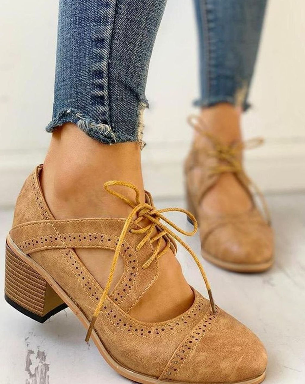 Beige vintage lace-up block-heel brogue T-strap shoes, worn with jeans