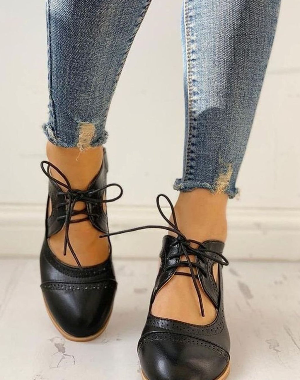Black vintage lace-up block-heel brogue T-strap shoes, worn with jeans