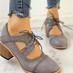 Grey vintage lace-up block-heel brogue T-strap shoes, worn with jeans