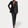 Black formal double-breasted trouser suit with peak lapels, tailored two-piece.
