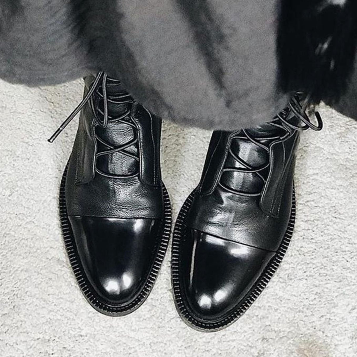 Product photo of the black lace-up leather cap-toe ankle boots for autumn