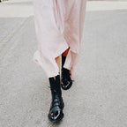 Product photo showing the black lace-up leather cap-toe ankle boots for autumn