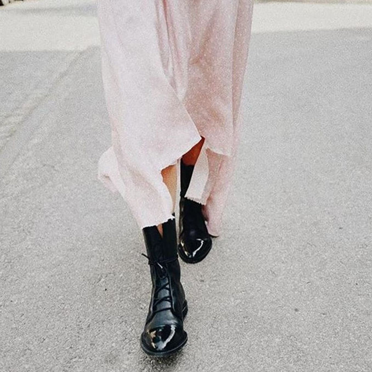 Product photo showing the black lace-up leather cap-toe ankle boots for autumn