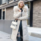 White midi-length quilted coat with a faux fur hood trim, warm winter outerwear.