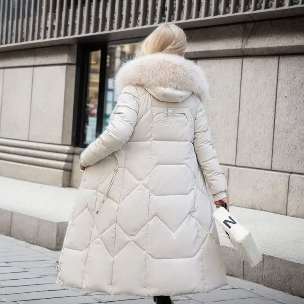 White midi-length quilted coat, cosy faux fur hood trim and padded warmth.