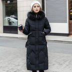 White quilted midi coat, faux fur hood trim styled for cold winter weather.