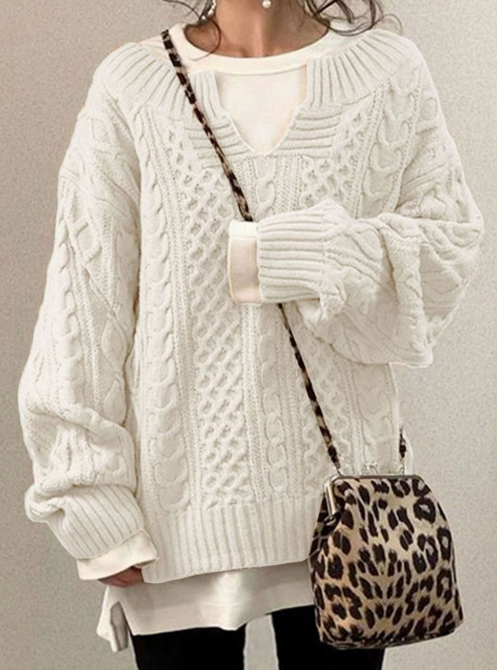 White oversized cable knit jumper, cable knit detail shown from another angle.