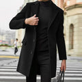 Men's tailored wool-blend overcoat in black with flap pockets.