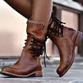 Brown lace-up mid-calf boots with block heel, worn with a denim skirt