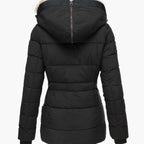 Women's hooded puffer jacket in pink with quilted panels and faux fur trim