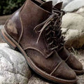 Dark brown rugged ankle-height leather lace-up boots for men
