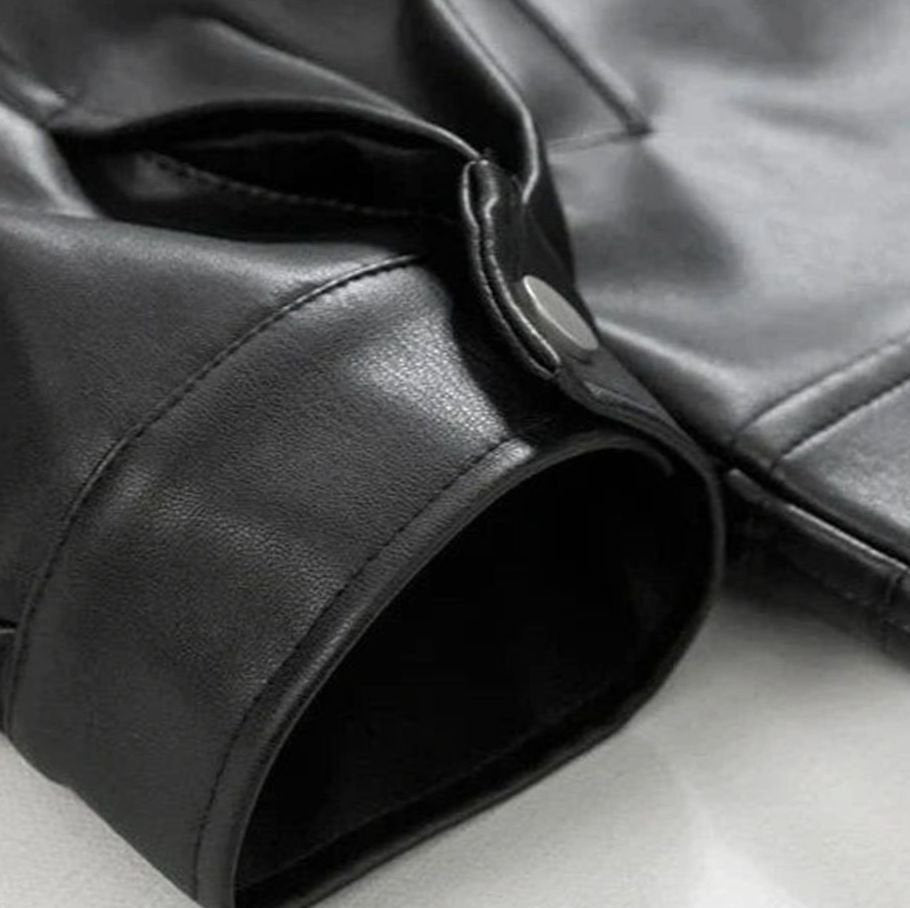 Men's oversized bomber jacket in black faux leather with buttoned cuffs.