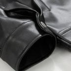 Men's oversized bomber jacket in black faux leather with buttoned cuffs.