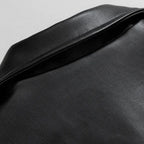 Black buttoned-cuff bomber jacket for men in an oversized faux leather design.