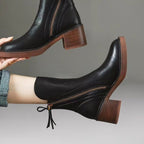Product photo showing the black genuine leather side-zip block heel ankle boots