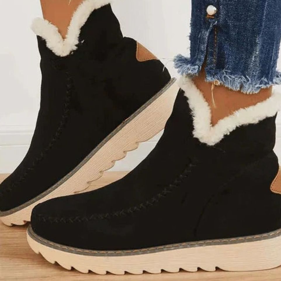 Women's faux fur-lined slip-on ankle boots in black with a non-slip sole
