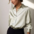 Women's loose fit satin blouse in green with long sleeves and a button-down front