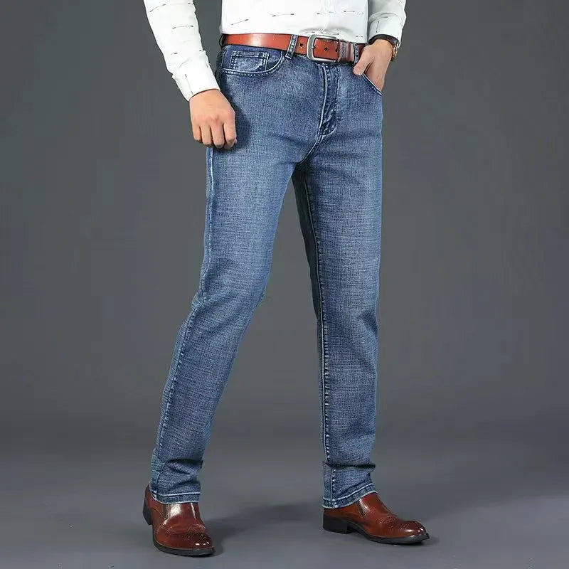 Blue stretch straight-fit jeans for men, worn on model, side view