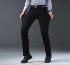 Black stretch straight-fit jeans for men, worn on model, front view