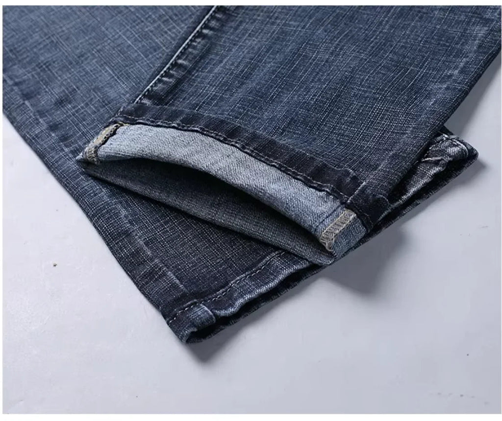 Navy blue stretch straight-fit jeans for men, close-up of the hem detail