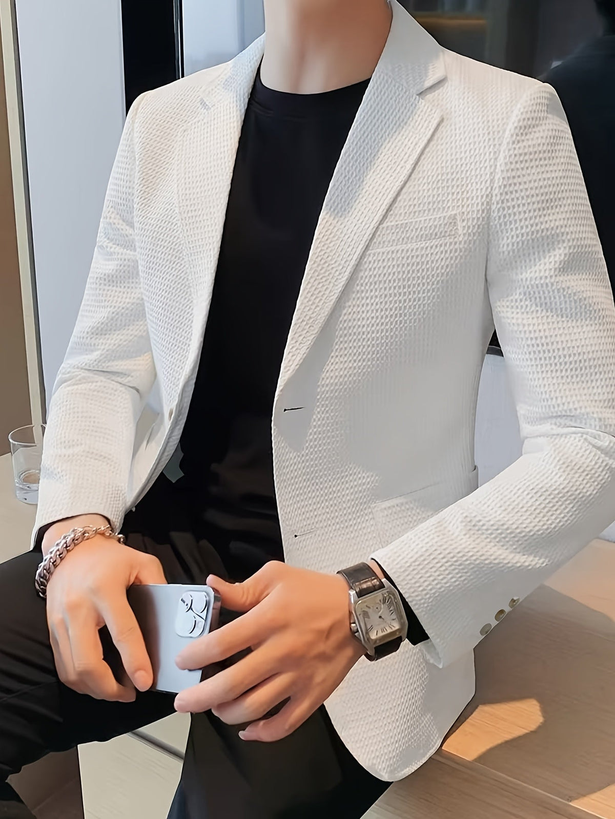 White waffle knit blazer with a notch lapel, worn open over a casual outfit.
