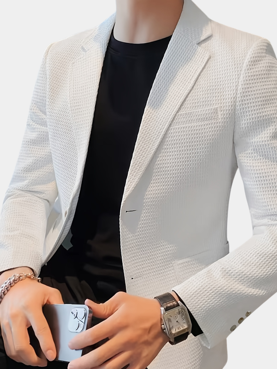 White waffle knit blazer with a notch lapel, worn open over a casual outfit.