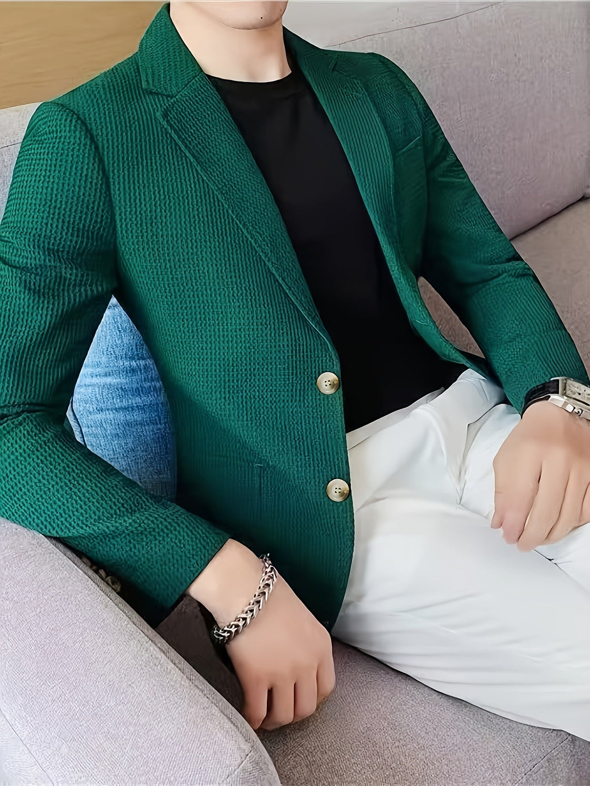 Green waffle knit blazer with a notch lapel, worn open over a casual outfit.