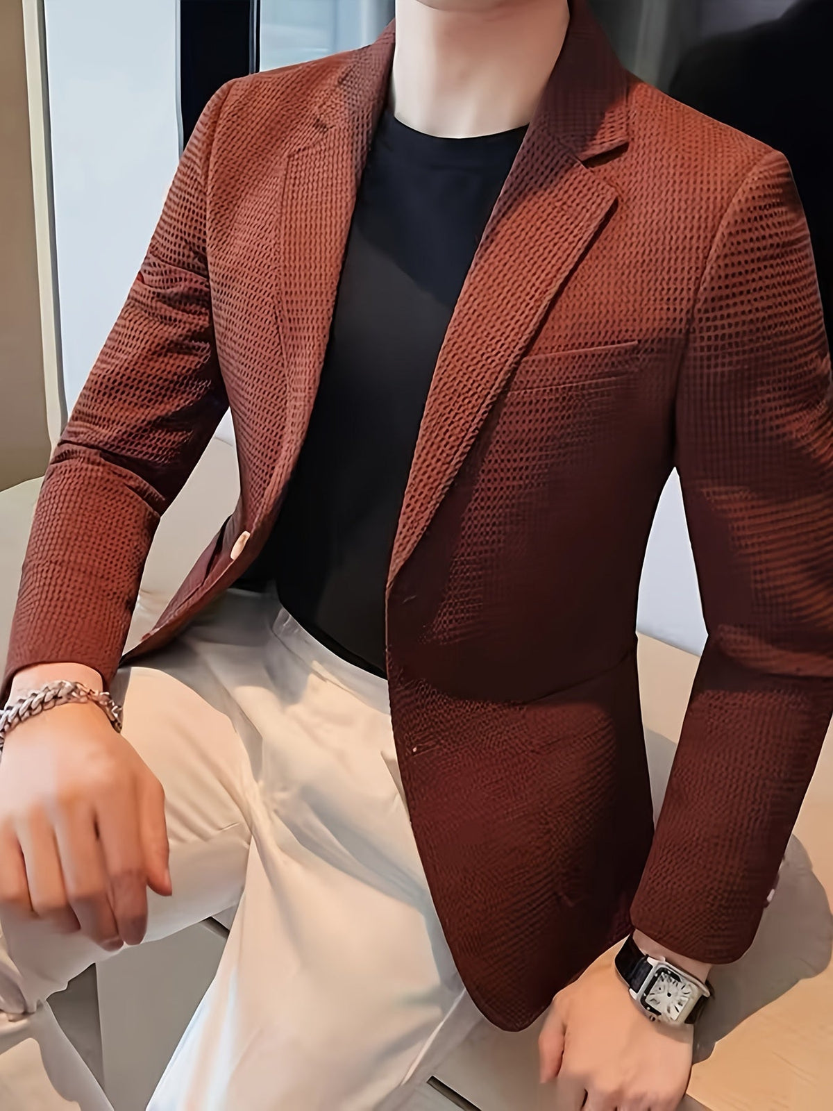 Red waffle knit blazer with a notch lapel, worn open over a casual outfit.