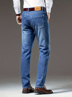 Blue regular-fit straight-leg jeans, rear view in washed stretch denim