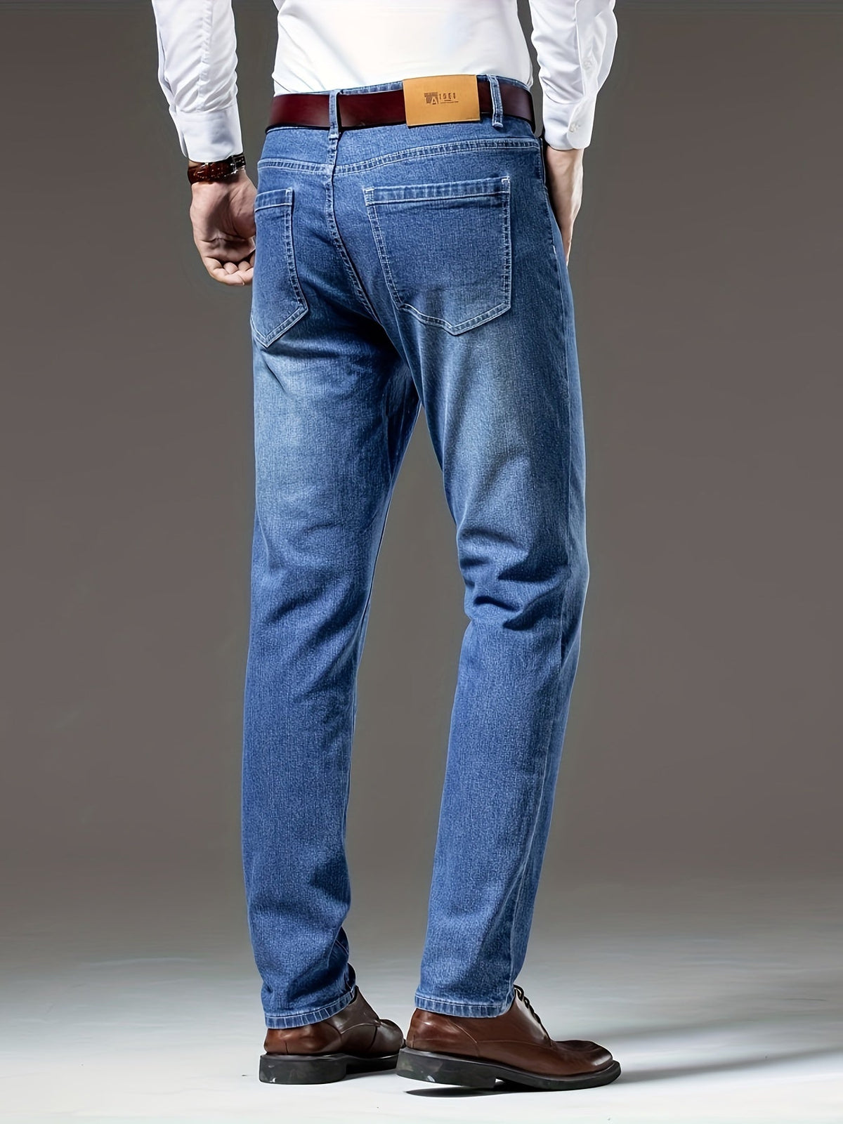 Blue regular-fit straight-leg jeans, rear view in washed stretch denim