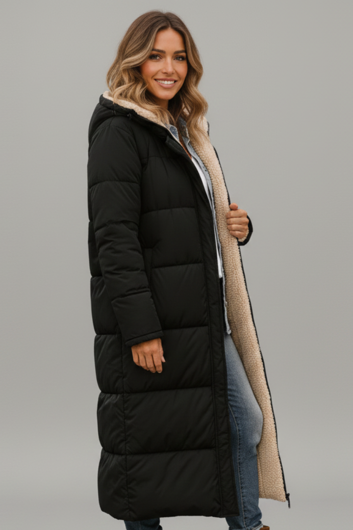 Women's quilted long coat in black, side view with the hood up