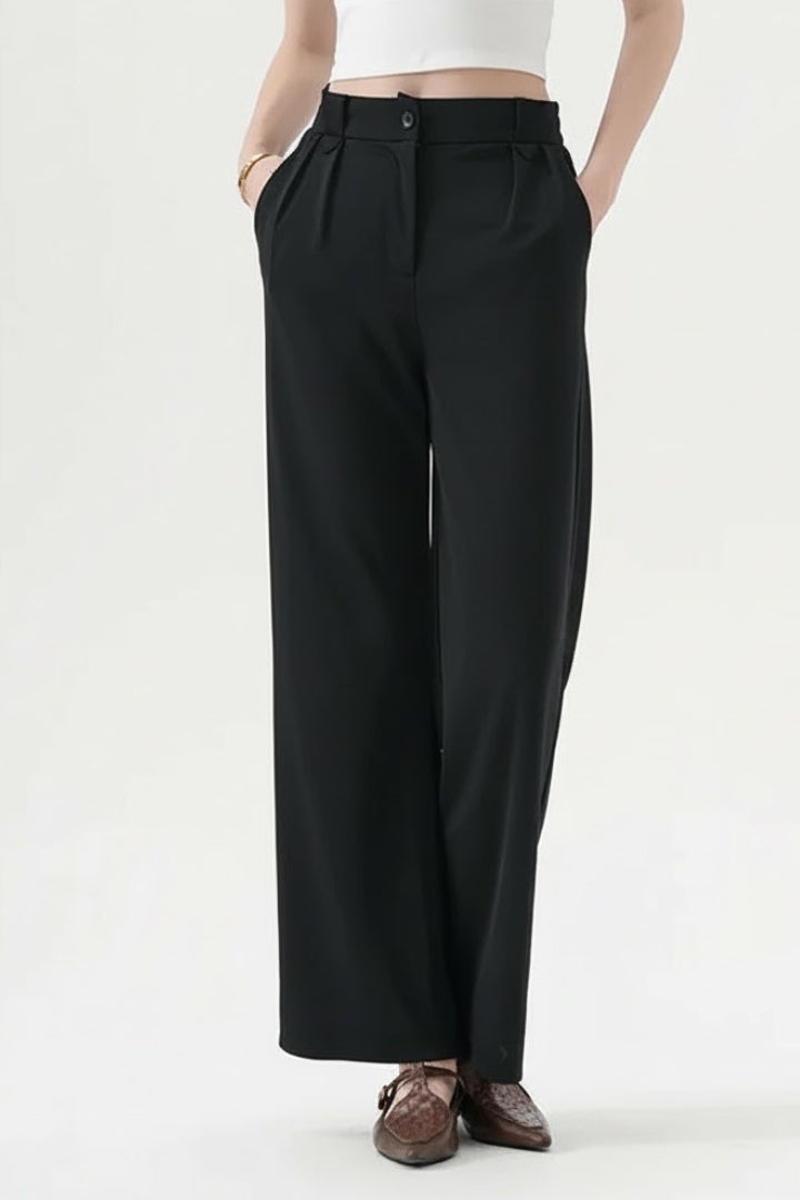 Black straight-leg trousers with a pleated waist, close-up front view