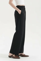 Black straight-leg trousers, side profile with hand in pocket