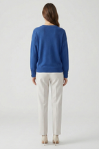 Women's V-neck knitted jumper in blue, back view with dropped shoulders