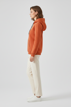 Women's fleece-lined pullover hoodie in burnt orange with ribbed cuffs
